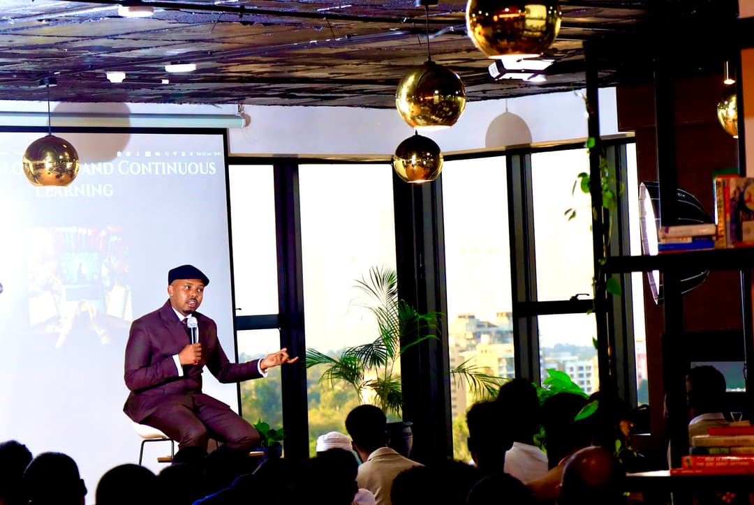 Far shot of stage with seated speaker